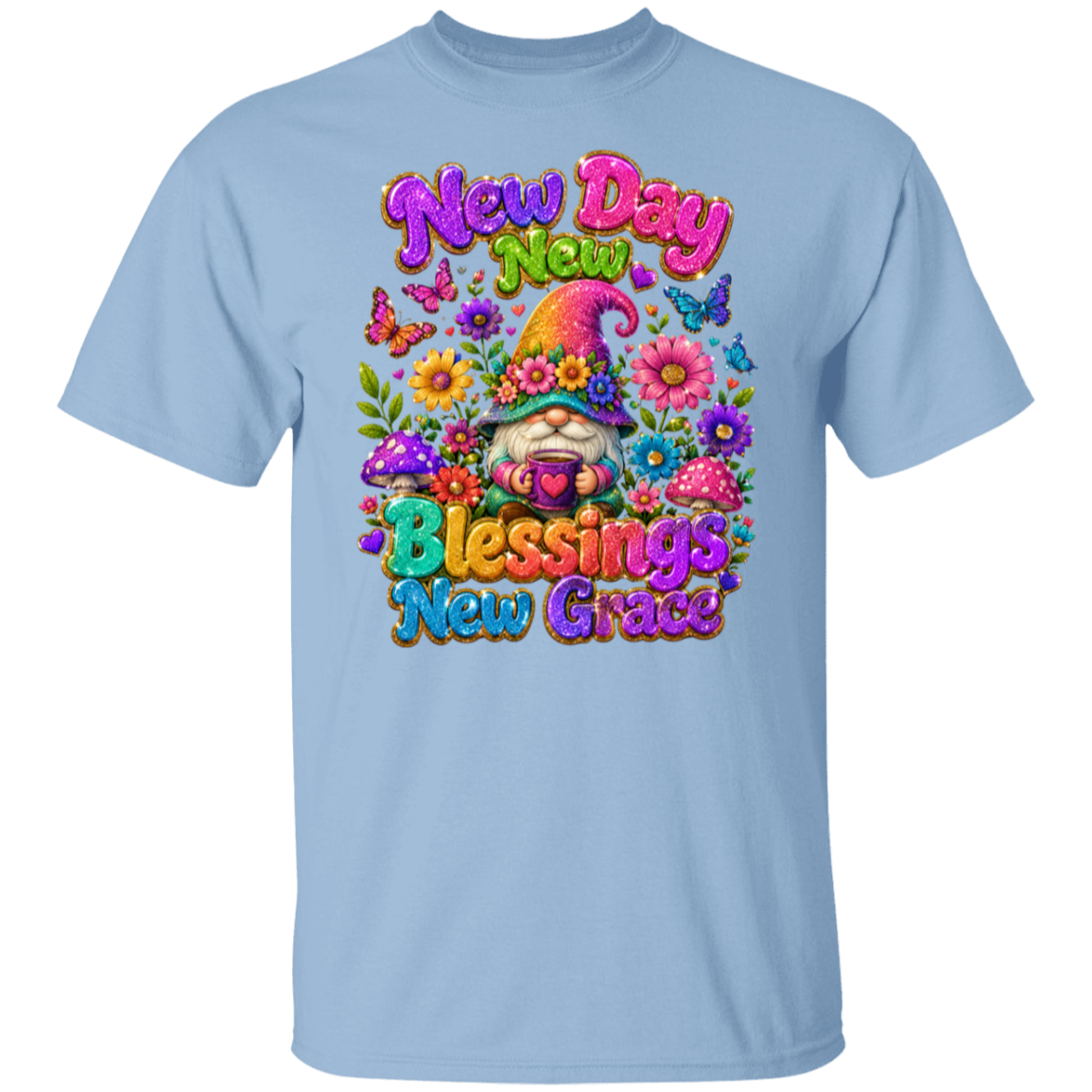 A light blue crewneck t-shirt featuring a colorful graphic print on the front with a gnome, flowers, butterflies, and the text 'New Day New Blessings New Grace'.