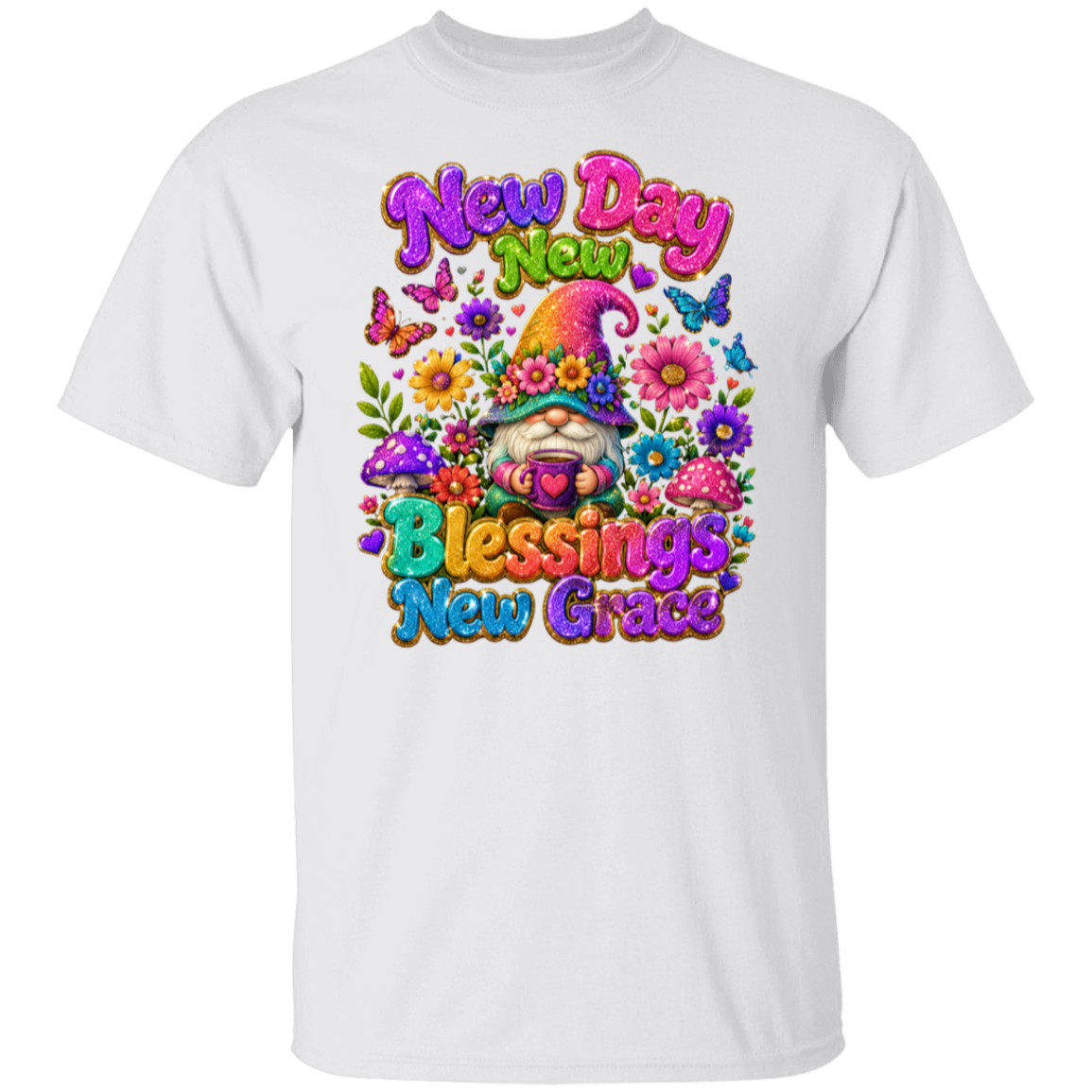A white short-sleeve crewneck t-shirt featuring a colorful graphic print on the front. The graphic displays a smiling gnome surrounded by flowers, butterflies, and mushrooms, with the text 'New Day New Blessings New Grace' in a vibrant, bubbly font.