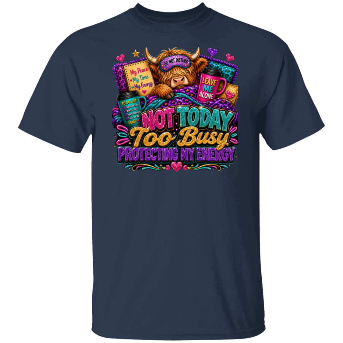 A navy blue short-sleeve t-shirt with a colorful graphic print on the front. The graphic features a highland cow wearing a sleep mask that says 'NOT NOW', surrounded by books, a mug, and a sign that says 'MY LIFE IS TOO BUSY TO LET YOU WAKE ME UP'.