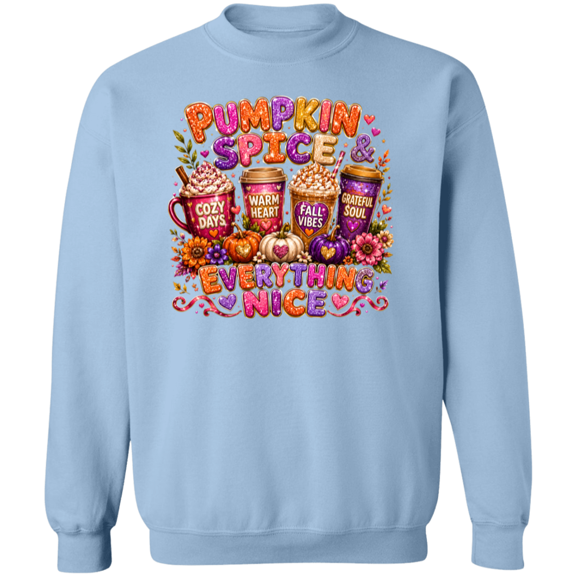 A light blue crewneck sweatshirt featuring a colorful autumn-themed graphic with the text 'Pumpkin Spice & Everything Nice' and illustrations of hot cocoa mugs, pumpkins, and fall leaves.