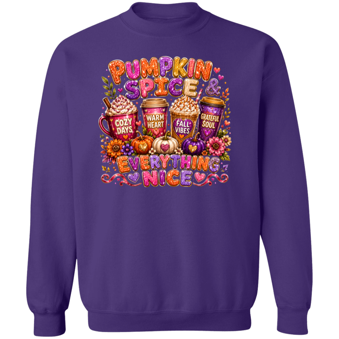 A purple crewneck sweatshirt featuring a colorful graphic print on the front with the text 'Pumpkin Spice & Everything Nice' and illustrations of hot cocoa mugs, pumpkins, hearts, and autumn flowers.