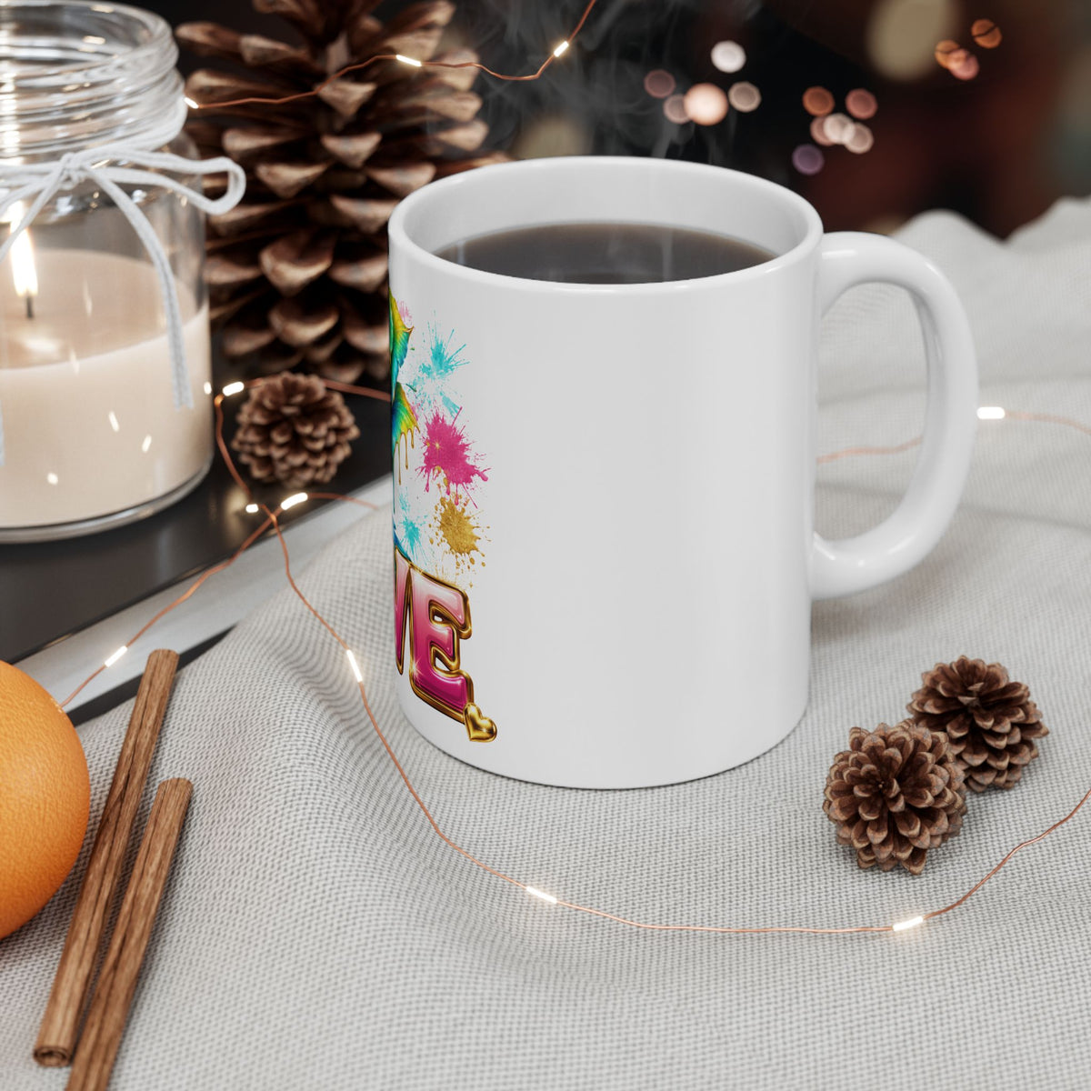 White mug with 'Queen of the Five Vibes Caroline' design on a table with decorative items.