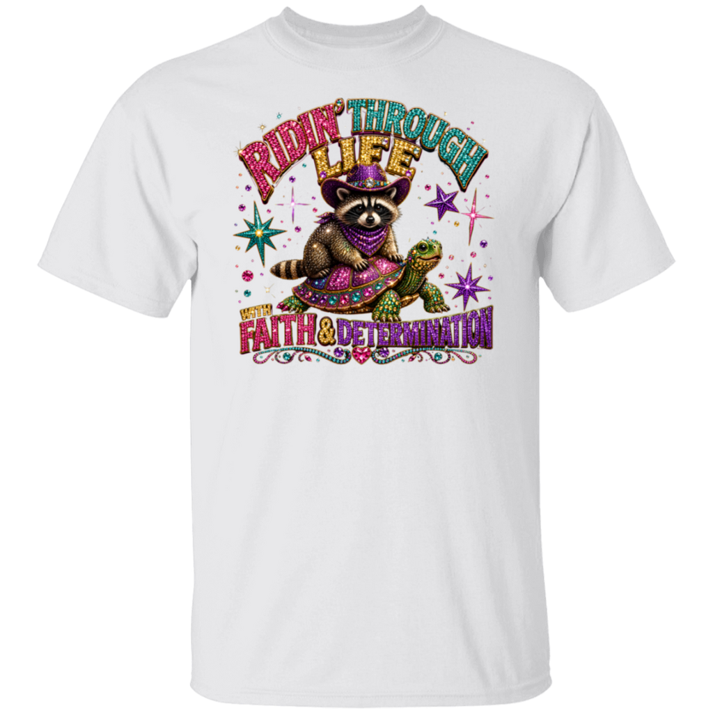 A white short-sleeve crewneck t-shirt featuring a colorful graphic print of a raccoon wearing a purple hat and bandana, riding a turtle with the text 'RIDE THROUGH LIFE WITH FAITH & DETERMINATION'.
