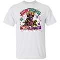 A white short-sleeve crewneck t-shirt featuring a colorful graphic print of a raccoon wearing a purple hat and bandana, riding a turtle with the text 'RIDE THROUGH LIFE WITH FAITH & DETERMINATION'.