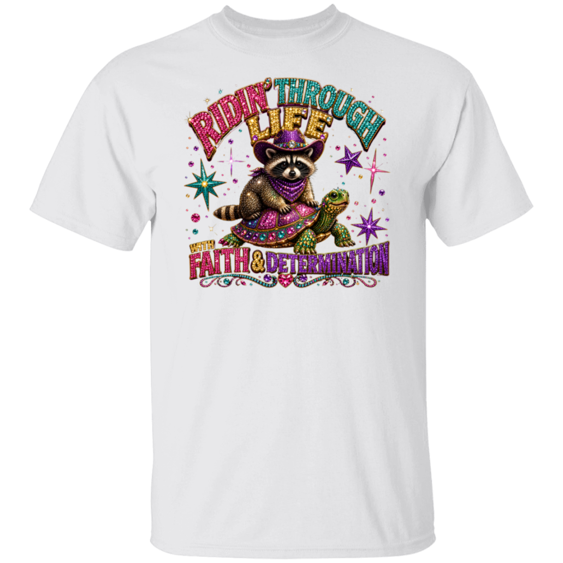 A white short-sleeve crewneck t-shirt featuring a colorful graphic print of a raccoon wearing a purple hat and bandana, riding a turtle with the text 'RIDE THROUGH LIFE WITH FAITH & DETERMINATION'.