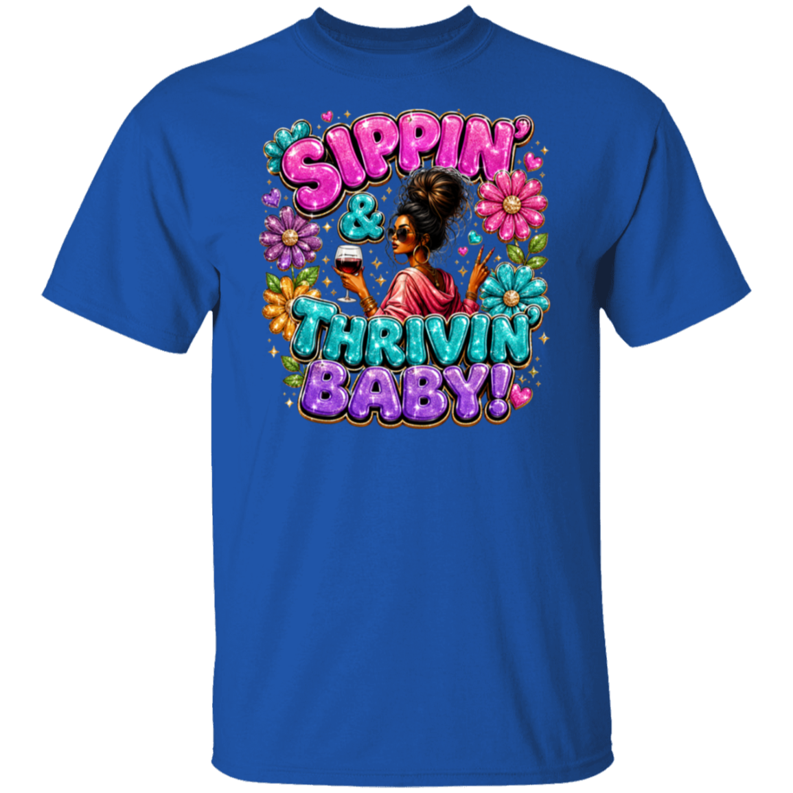 A royal blue short-sleeve t-shirt with a colorful retro graphic on the chest featuring the text 'Sippin' & Thrivin' Baby!' in pink and teal bubble letters, surrounded by flowers and a central figure.
