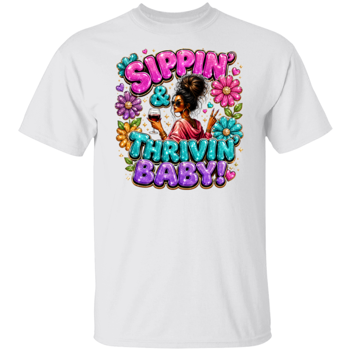 A white short-sleeve crewneck t-shirt featuring a colorful graphic print on the front. The graphic displays the text 'Sippin' & Thrivin' Baby!' in bubbly pink, purple, and teal lettering, surrounded by a cartoon illustration of a Black woman with an afro holding a drink, framed by pink and blue flowers.