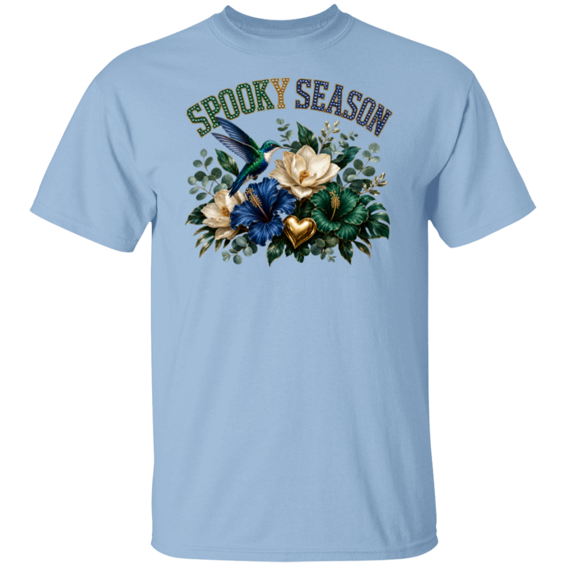A light blue crewneck t-shirt featuring a 'Spooky Season' graphic on the chest with a hummingbird, flowers, and a gold heart.