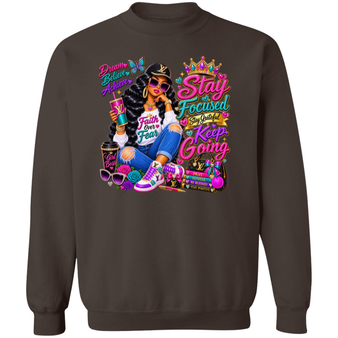 A dark chocolate crewneck sweatshirt featuring a large, colorful graphic print on the front. The graphic depicts a woman in a black and white striped shirt, blue jeans, and purple sneakers, holding a drink, surrounded by motivational text like 'Stay Focused', 'Keep Going', and 'Beauty Believes Achieve'.
