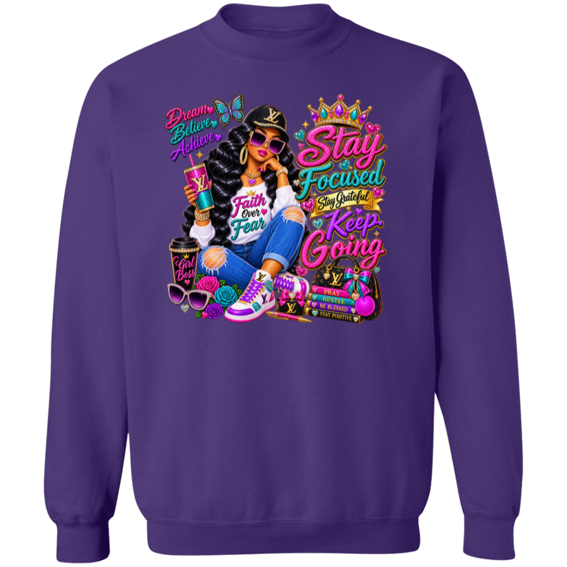 A purple crewneck sweatshirt featuring a colorful graphic print on the front. The graphic depicts a woman in a black jacket and jeans holding a drink, surrounded by motivational text like 'Beauty Believes Always', 'Stay Focused Stay Useful Keep Going', and 'Faith Over Fear', with Louis Vuitton-style monogram details.