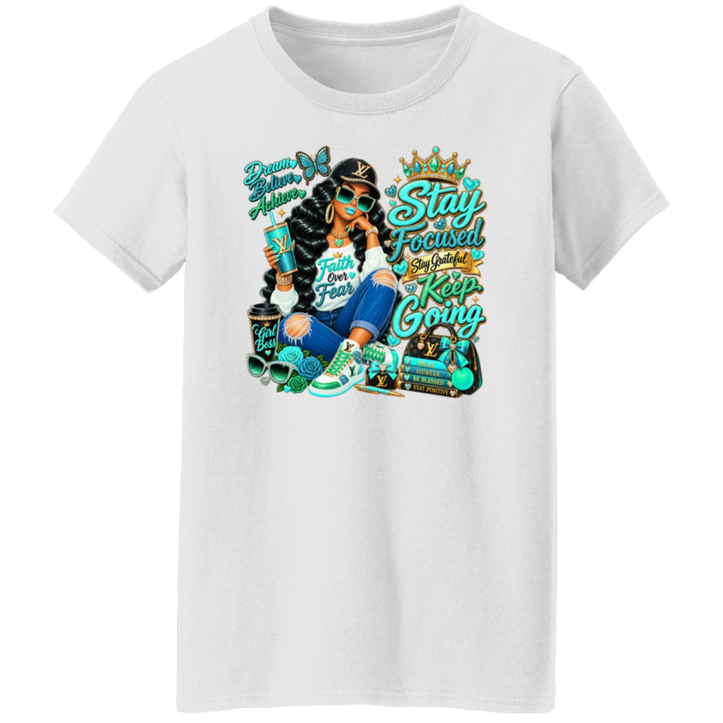A white short-sleeve crewneck t-shirt featuring a colorful graphic print of a woman with braided hair, sunglasses, and a crown, surrounded by motivational text like 'Stay Focused', 'Keep Going', and 'Dream Big'.