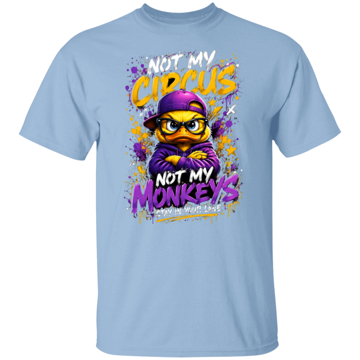 A light blue crewneck t-shirt featuring a colorful graphic print of a cartoon monkey wearing a purple cap and hoodie, with the text 'NOT MY CIRCUS NOT MY MONKEYS' in yellow, purple, and white.