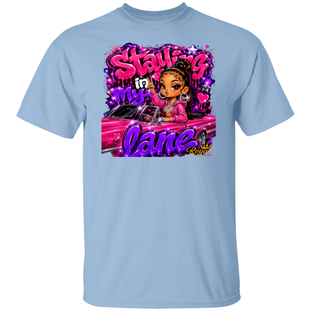 A light blue crewneck t-shirt featuring a colorful graphic print on the front. The graphic displays a cartoon girl with brown hair in a bun, wearing a pink jacket, sitting in a pink car, surrounded by graffiti-style text that reads 'Staying in my lane' and 'Crazy'.