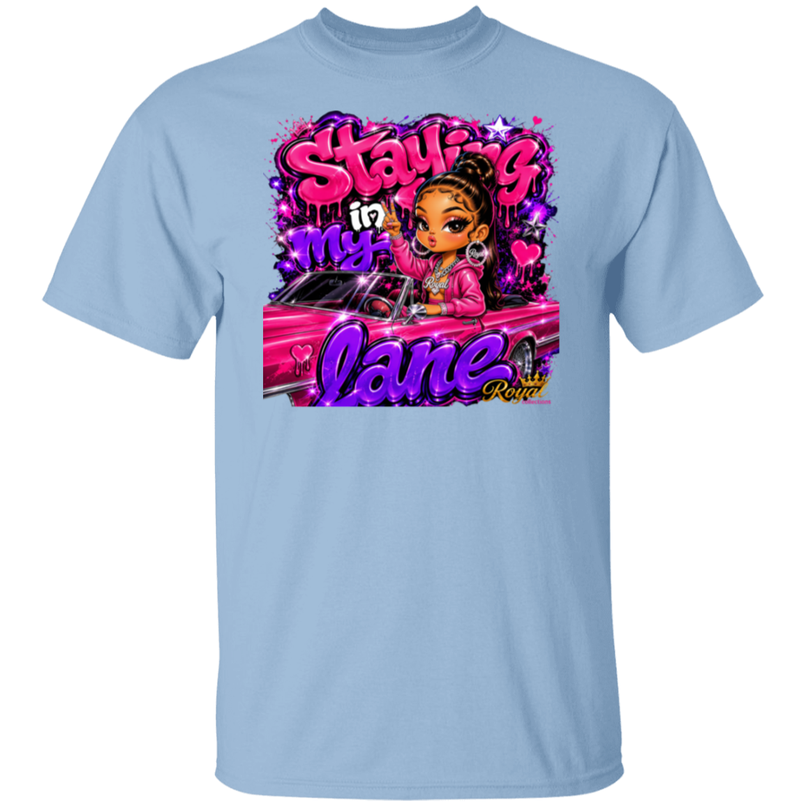 A light blue crewneck t-shirt featuring a colorful graphic print on the front. The graphic displays a cartoon girl with brown hair in a bun, wearing a pink jacket, sitting in a pink car, surrounded by graffiti-style text that reads 'Staying in my lane' and 'Crazy'.