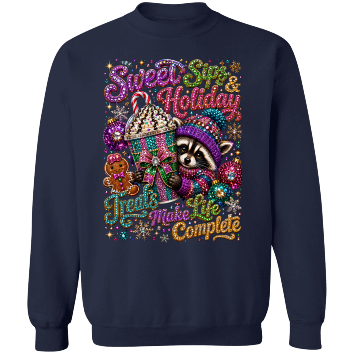 A navy blue crewneck sweatshirt featuring a colorful, festive graphic print of a raccoon, a cupcake, a gingerbread cookie, and holiday-themed text that reads 'Sweet Sips & Holiday Treats Make Life Complete'.