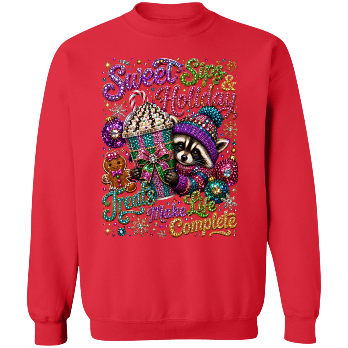 A red crewneck sweatshirt featuring a colorful, festive graphic of a raccoon in a knit hat next to a cupcake, with the text 'Sweet Sin & Holiday Fruits Make Life Complete' in glittery, multicolored lettering.