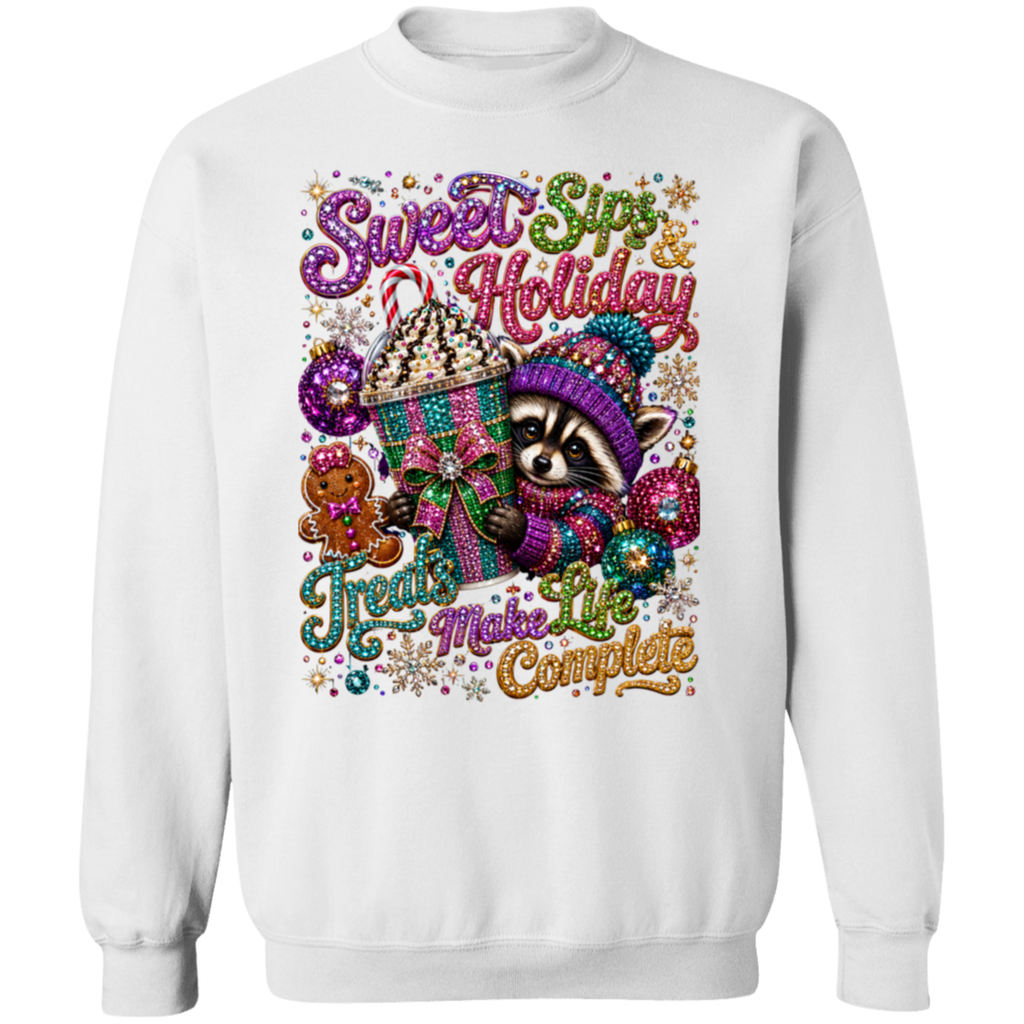 A white crewneck sweatshirt featuring a large, colorful, glittery graphic print of a raccoon in a knit hat next to a hot chocolate cup, with the text 'Sweet Snip Holiday Treats Make Life Complete'.