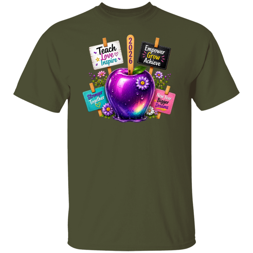 An olive green short-sleeve crewneck t-shirt featuring a colorful graphic of a purple and blue galaxy-adorned apple with flowers, surrounded by signs that read 'Teach Love Inspire', '2026', 'Empower Grow Achieve', 'Shine Together', and 'Have Bigger Dreams'.