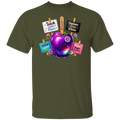 An olive green short-sleeve crewneck t-shirt featuring a colorful graphic of a purple and blue galaxy-adorned apple with flowers, surrounded by signs that read 'Teach Love Inspire', '2026', 'Empower Grow Achieve', 'Shine Together', and 'Have Bigger Dreams'.
