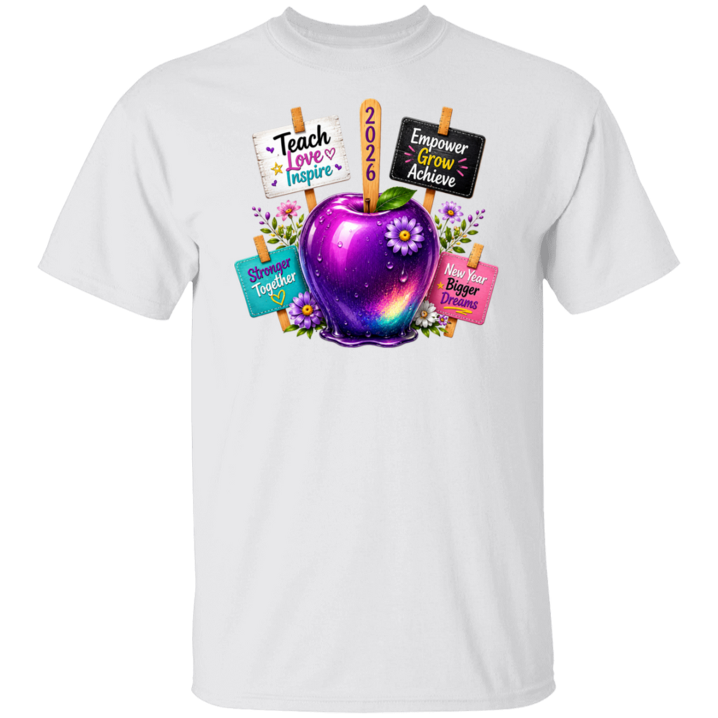 A white short-sleeve crewneck t-shirt featuring a colorful graphic of a glowing purple galaxy apple with flowers and signs that read 'Teach Love Inspire', '2026', 'Empower Grow Achieve', 'Show Up Together', and 'Have Bigger Dreams'.