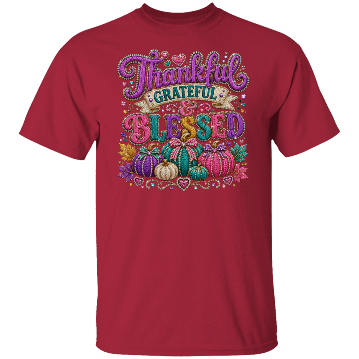 A cardinal color short-sleeve crewneck t-shirt featuring a colorful graphic on the front with the words 'Thankful Grateful Blessed' and decorative pumpkins, hearts, and autumn motifs.