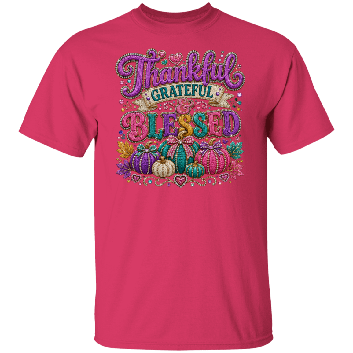 A heliconia color short-sleeve t-shirt with a colorful graphic on the chest that reads 'Thankful Grateful Blessed' in decorative lettering above a cluster of pumpkins, shown on a plain white background.