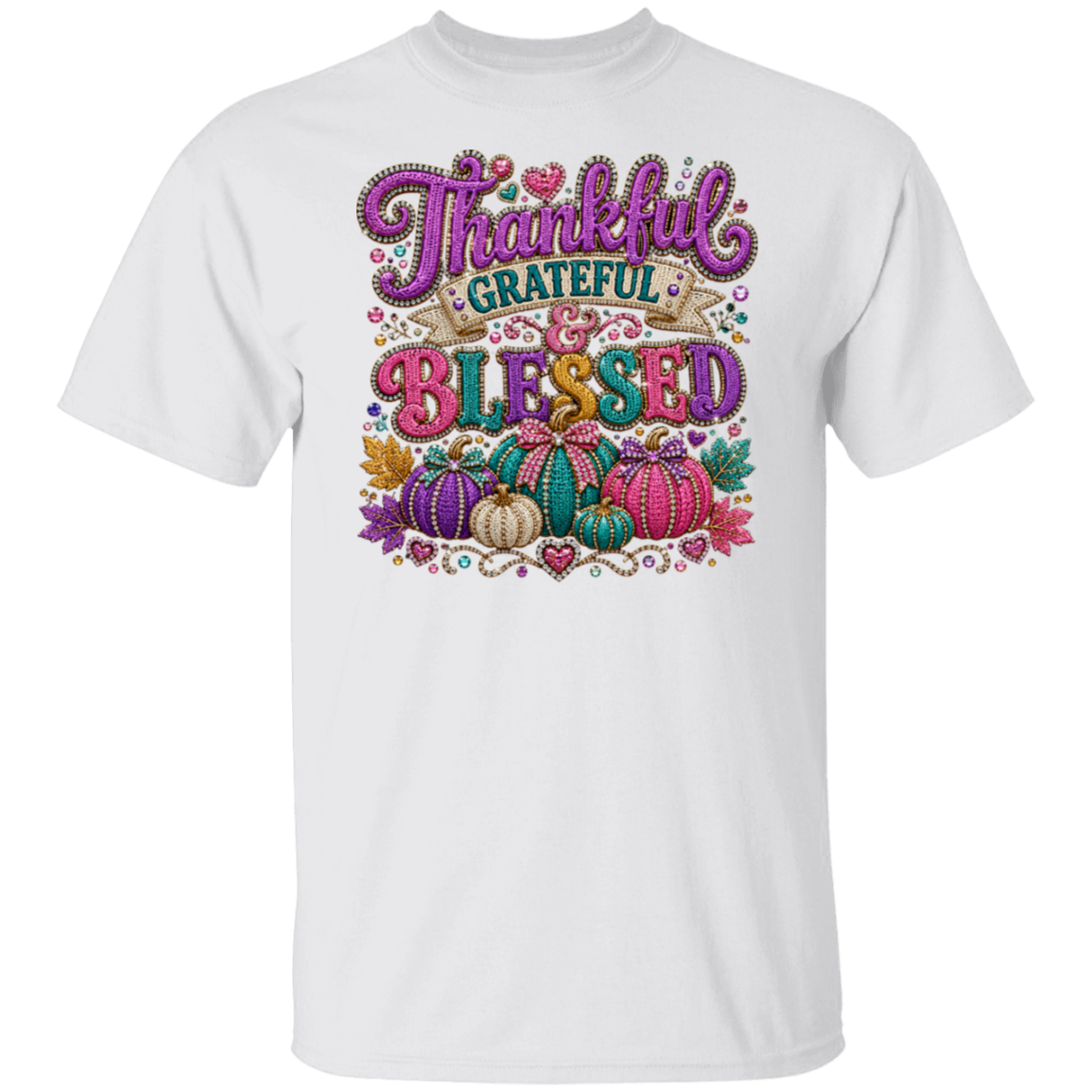 A white color short-sleeve crewneck t-shirt featuring a colorful autumn-themed graphic on the chest with the text 'Thankful Grateful Blessed' and illustrations of pumpkins, hearts, and leaves.