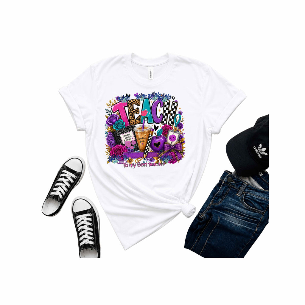 A white graphic t-shirt styled in a flat lay with black sneakers, blue jeans, and a black cap on a white background. The t-shirt features a colorful 'TEACH' graphic with flowers, a coffee cup, and the text 'To My Great Teacher'.
