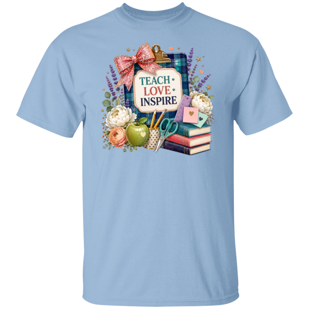 A light blue short-sleeve crewneck t-shirt featuring a colorful 'Teacher Love Inspire' graphic on the chest, displayed against a solid white background.