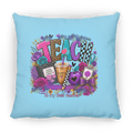 A square columbia blue throw pillow featuring a colorful graphic design with the word 'TEACH' in patterned letters, surrounded by flowers, a notebook, a drink, a heart, and the phrase 'To my Best Teacher!'.