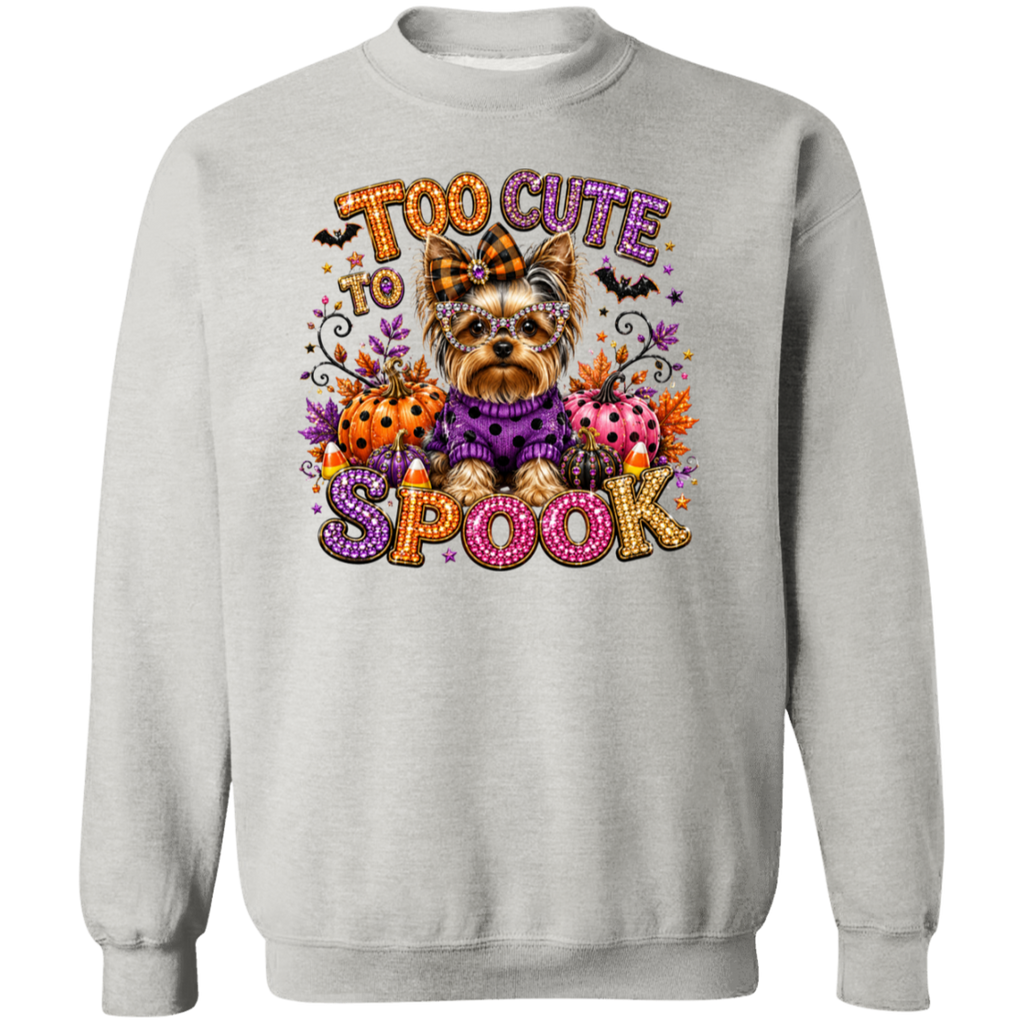 A lash crewneck sweatshirt featuring a colorful graphic print of a Yorkshire Terrier dressed in a purple sweater, surrounded by pumpkins, ladybugs, bats, and the text 'TOO CUTE TO SPOOK' in a decorative, glittery font.