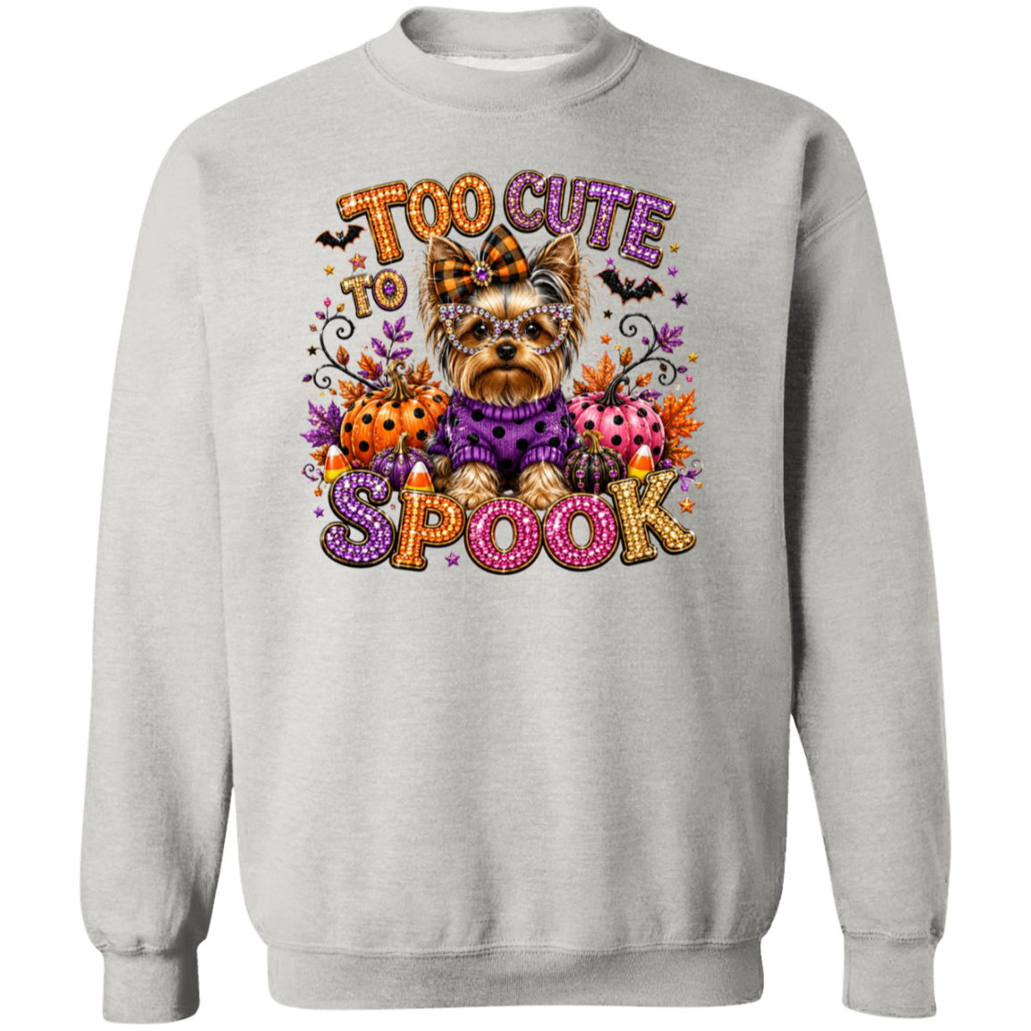 A lash crewneck sweatshirt featuring a colorful graphic print of a Yorkshire Terrier dressed in a purple sweater, surrounded by pumpkins, ladybugs, bats, and the text 'TOO CUTE TO SPOOK' in a decorative, glittery font.