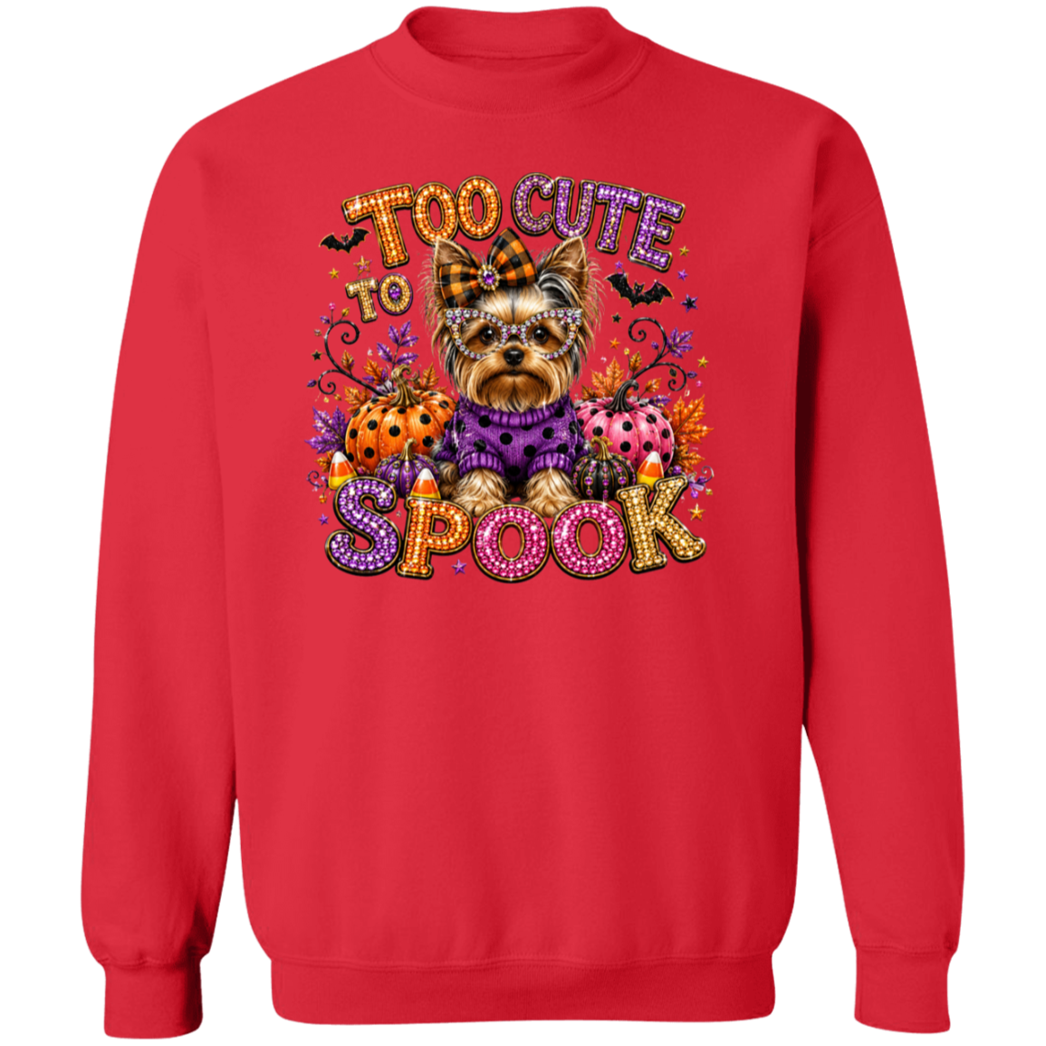 A red crewneck sweatshirt featuring a colorful graphic of a Yorkshire Terrier dressed in a purple sweater, surrounded by Halloween elements like pumpkins, candy corn, ladybugs, bats, and the text 'TOO CUTE TO SPOOK'.