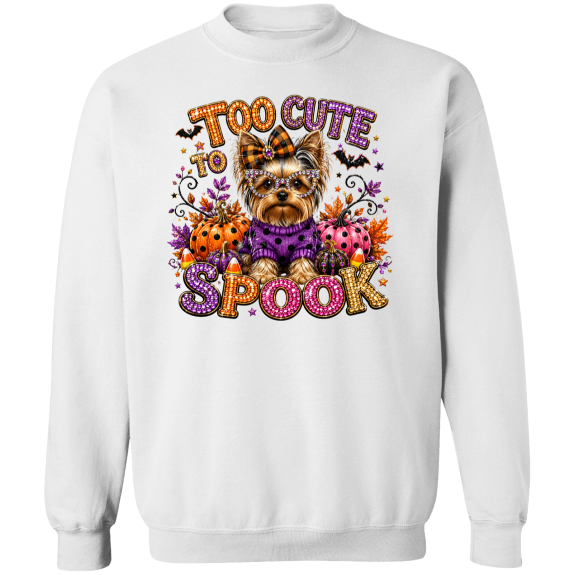A white crewneck sweatshirt featuring a colorful graphic of a small Yorkshire Terrier dressed in a purple sweater, surrounded by Halloween elements like pumpkins, ladybugs, bats, and the text 'TOO CUTE TO SPOOK'.