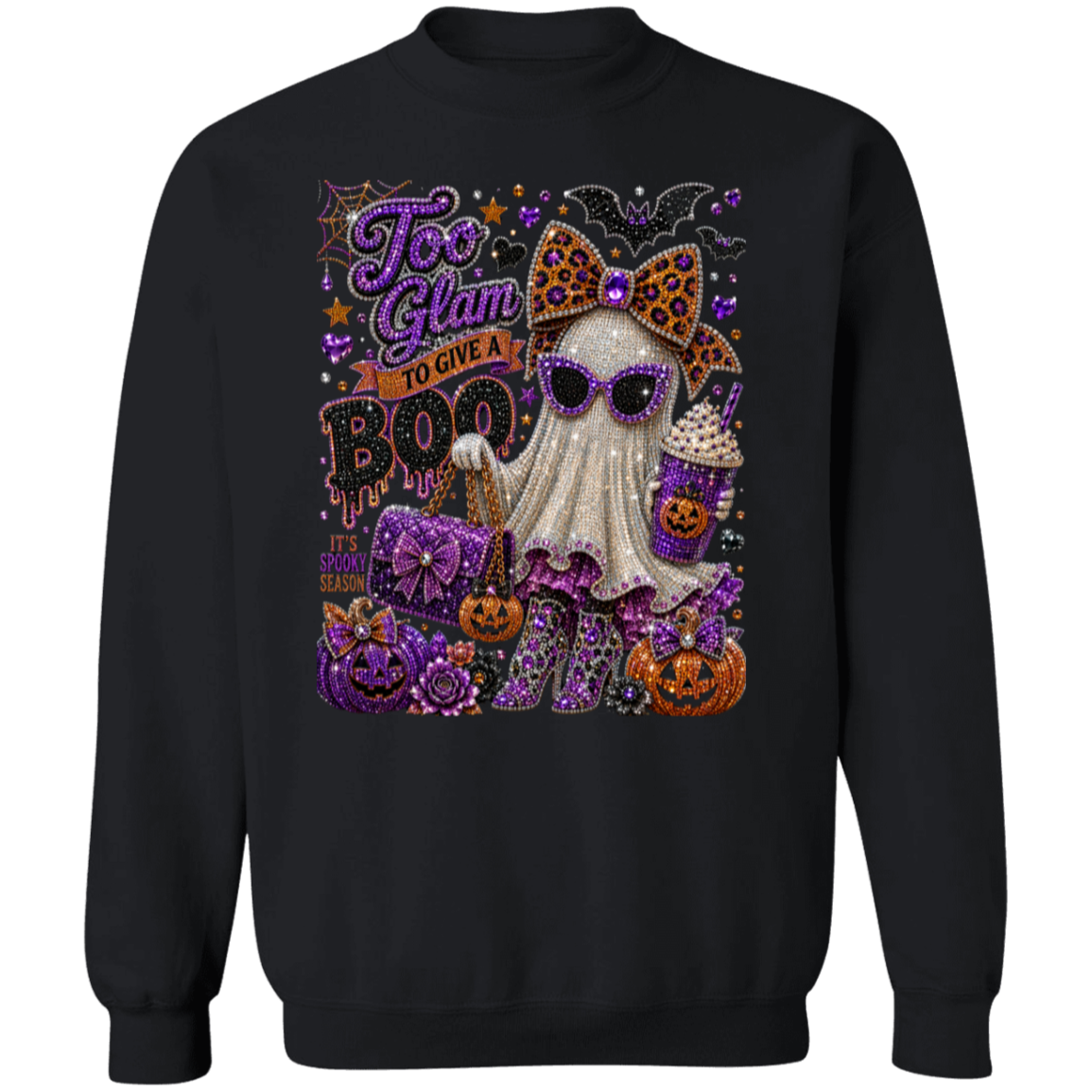 A black crewneck sweatshirt featuring a large, glittery Halloween graphic on the front. The graphic depicts a cute ghost character wearing purple sunglasses and a leopard-print bow, surrounded by jack-o'-lanterns, purple pumpkins, bats, and the text 'Too Glam To Give A BOO'.