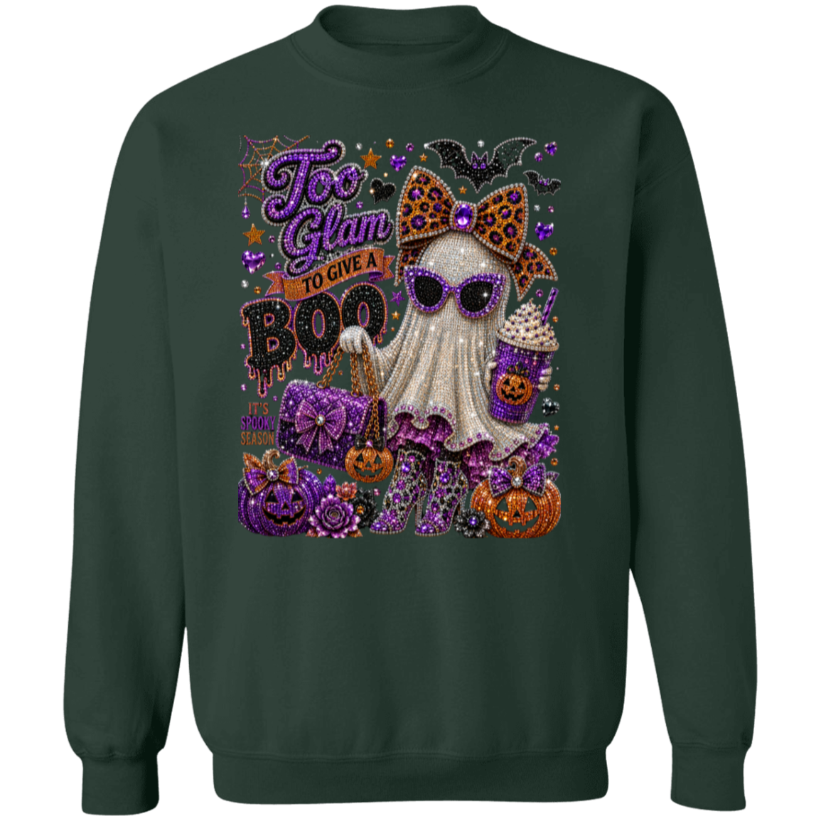 A dark forest green crewneck sweatshirt featuring a large, glittery Halloween graphic on the front. The graphic depicts a cute ghost character wearing purple sunglasses and a leopard-print bow, surrounded by jack-o'-lanterns, purple pumpkins, bats, and the text 'Too Glam To Give A BOO'.