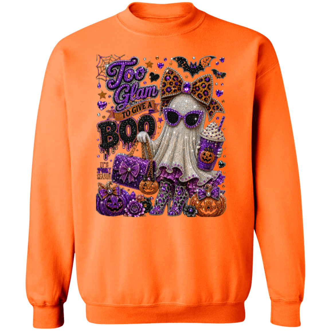 An orange crewneck sweatshirt featuring a large, detailed glittery graphic on the front with a ghost, pumpkins, bats, and the text 'Too Glam to Give a BOO'.