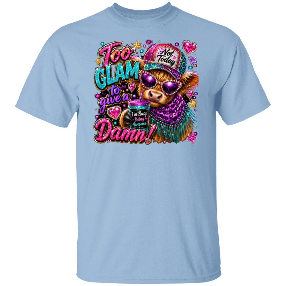 A light blue crewneck t-shirt featuring a colorful graphic print of a cow wearing sunglasses and a hat with the text 'Too Glam to give a Damn!'.