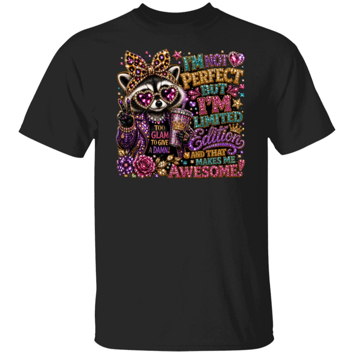 A black short-sleeve crewneck t-shirt featuring a colorful graphic print of a raccoon wearing a glittery crown and sunglasses, with the text 'I'M NOT PERFECT BUT I'M LIMITED Edition AND THAT MAKES ME AWESOME!' in a sparkling, multicolored font.