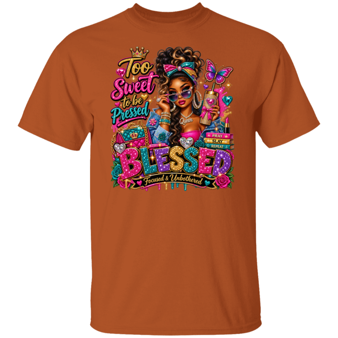 A Texas orange crewneck t-shirt featuring a colorful graphic print on the front. The graphic includes a stylized illustration of a woman with sunglasses, a butterfly, and the text 'Too Sweet to be Pressed' and 'BLESSED Focused & Unburdened TPTT'.
