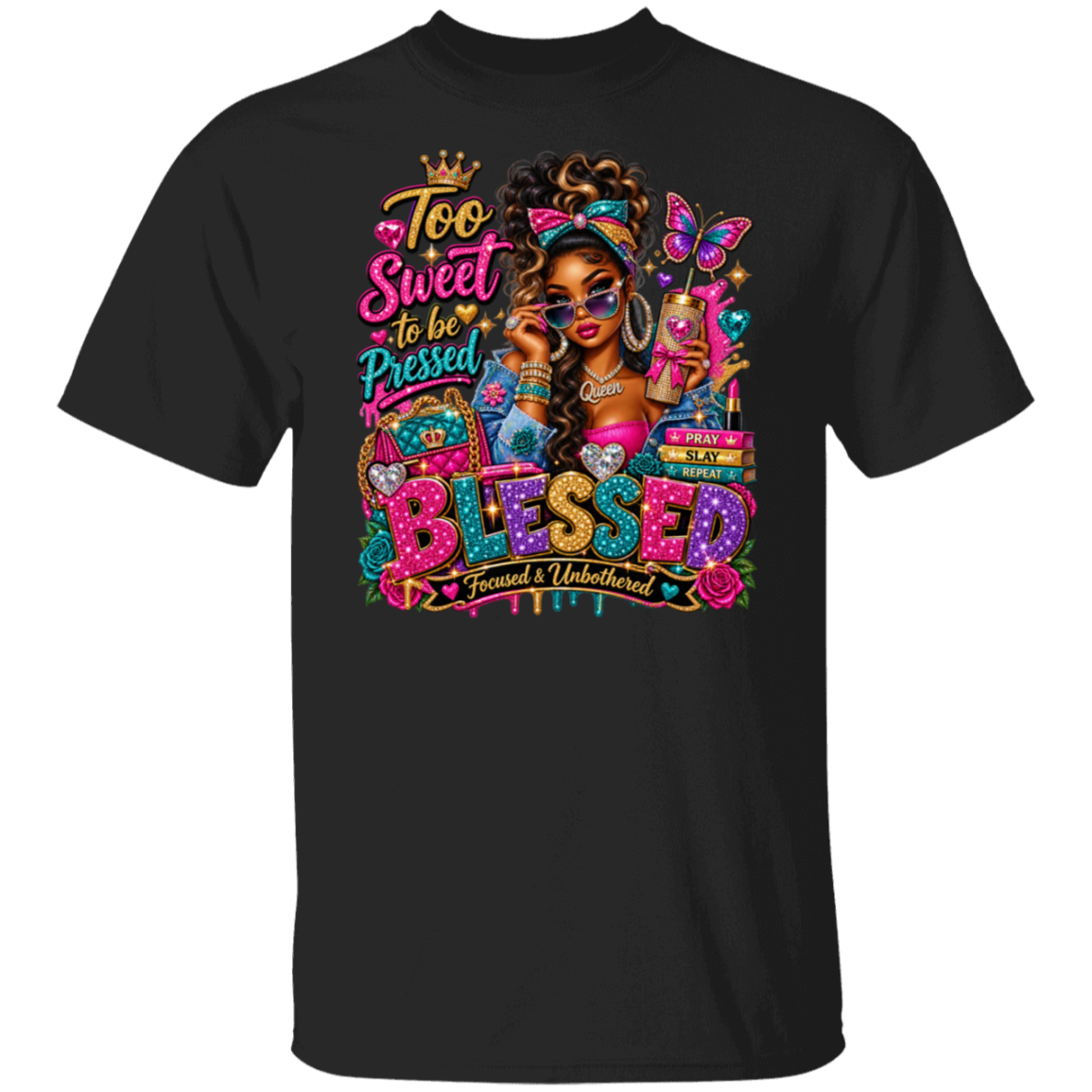 A black short-sleeve crewneck t-shirt featuring a vibrant, colorful graphic print on the front. The graphic includes a stylized illustration of a woman with sunglasses, a butterfly, and the text 'Too Sweet to be Pressed BLESSED Focused & Unburdened'.