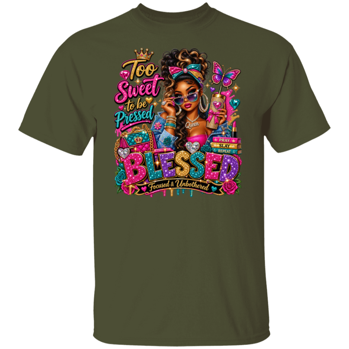 A military green short-sleeve t-shirt with a colorful graphic print on the front. The graphic features a stylized illustration of a woman with sunglasses, a butterfly, and the text 'Too Sweet to be Pressed BLESSED Focused & Unburdened'