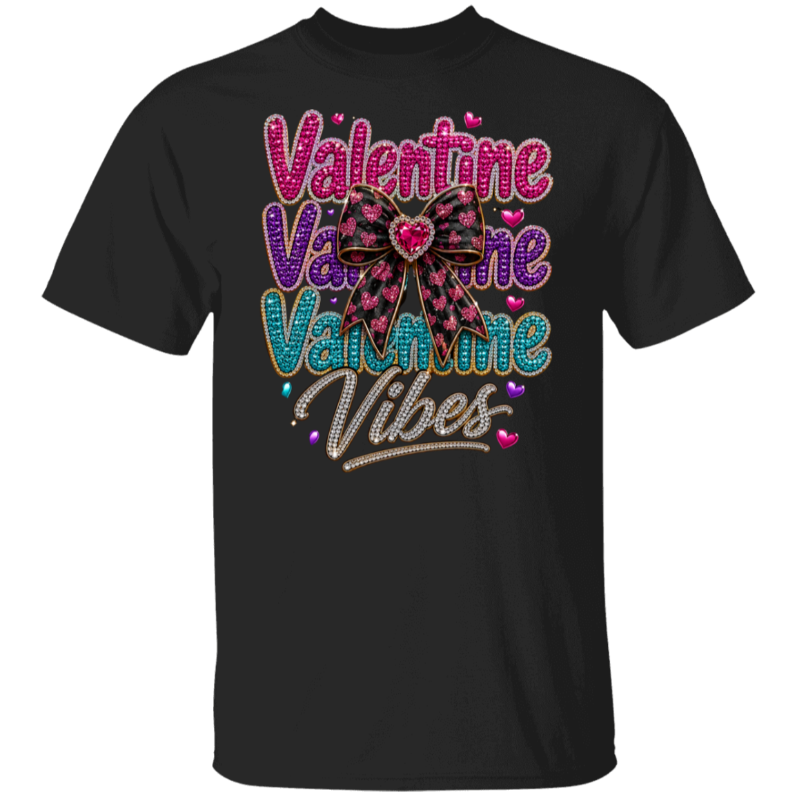 A black short-sleeve crewneck t-shirt featuring a colorful graphic on the front with the text 'Valentine Vibes' in pink, purple, and blue glitter-style lettering, accented by a pink and black bow with a heart in the center.