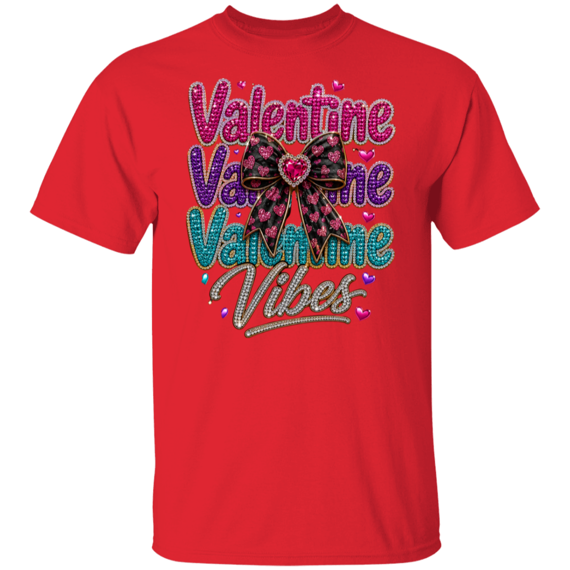 A red short-sleeve crewneck t-shirt featuring a colorful graphic on the front that reads 'Valentine Valentine Valentine Vibes' in pink, purple, and blue glitter-style lettering with a bow motif.