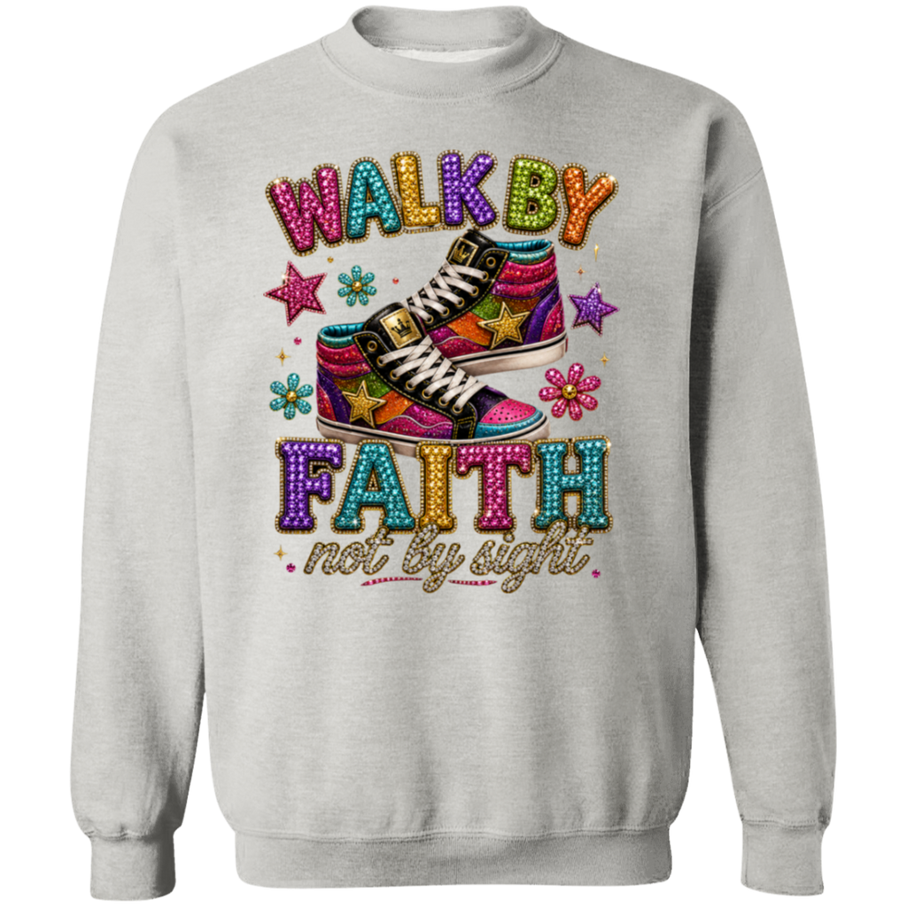 An ash color crewneck sweatshirt featuring a colorful graphic print with the text 'WALK BY FAITH not by sight' and an illustration of pink and purple high-top sneakers decorated with stars.