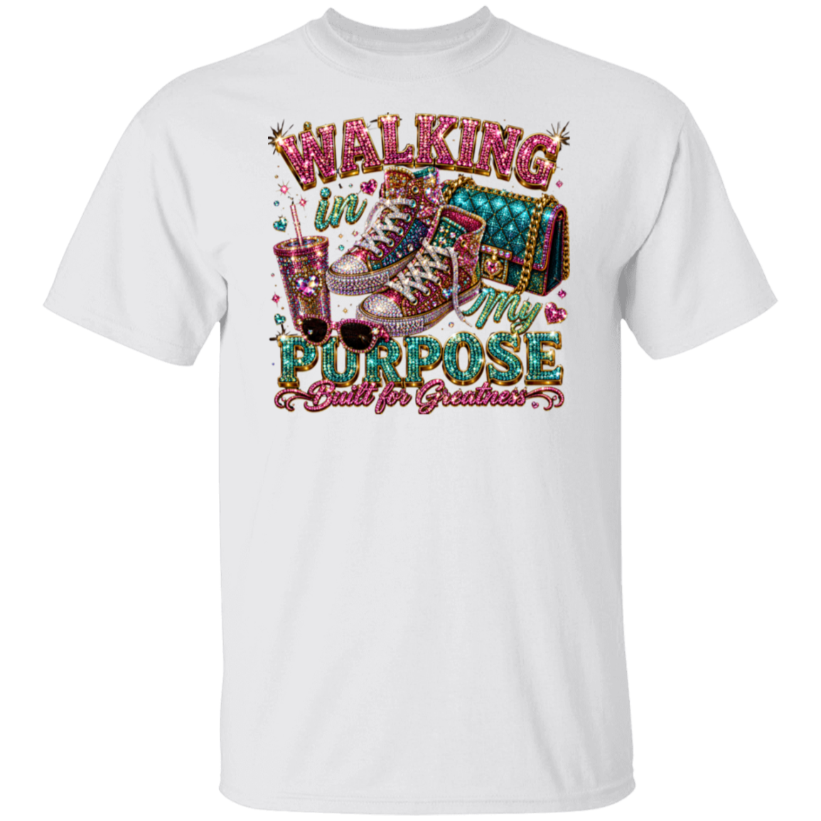 A white short-sleeve crewneck t-shirt featuring a colorful graphic print on the front. The graphic displays a glittery high-heel shoe, a drink with straws, and a suitcase, surrounded by the text 'WALKING IN MY PURPOSE Built for Greatness' in stylized glittery fonts.