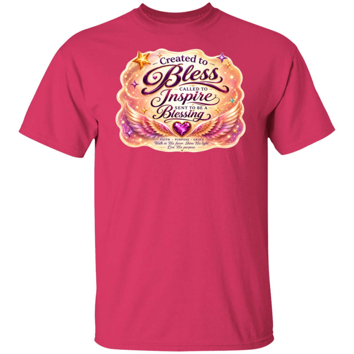 A heliconia color short-sleeve crewneck t-shirt featuring a large graphic print on the chest. The graphic displays a glowing, angelic design with the text 'Created to Bless Called to Inspire Love in the Blessing' in stylized fonts, surrounded by golden wings, stars, and a purple heart.