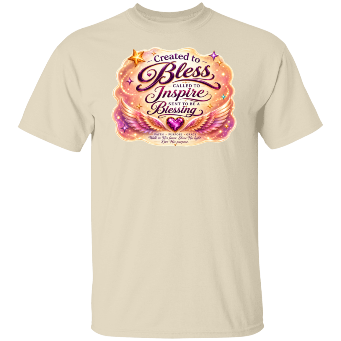 A natural crewneck t-shirt featuring a colorful graphic print on the chest with the text 'Created to Bless Called to Inspire Love in the Blessing' surrounded by pink, orange, and purple angel wings and stars.