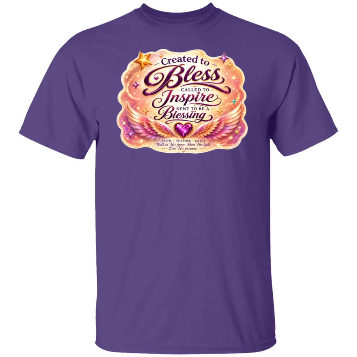 A purple short-sleeve crewneck t-shirt featuring a large graphic print on the chest with the words 'Created to Bless Called to Inspire Live in the Blessing' in stylized script over a pink, orange, and gold winged design.