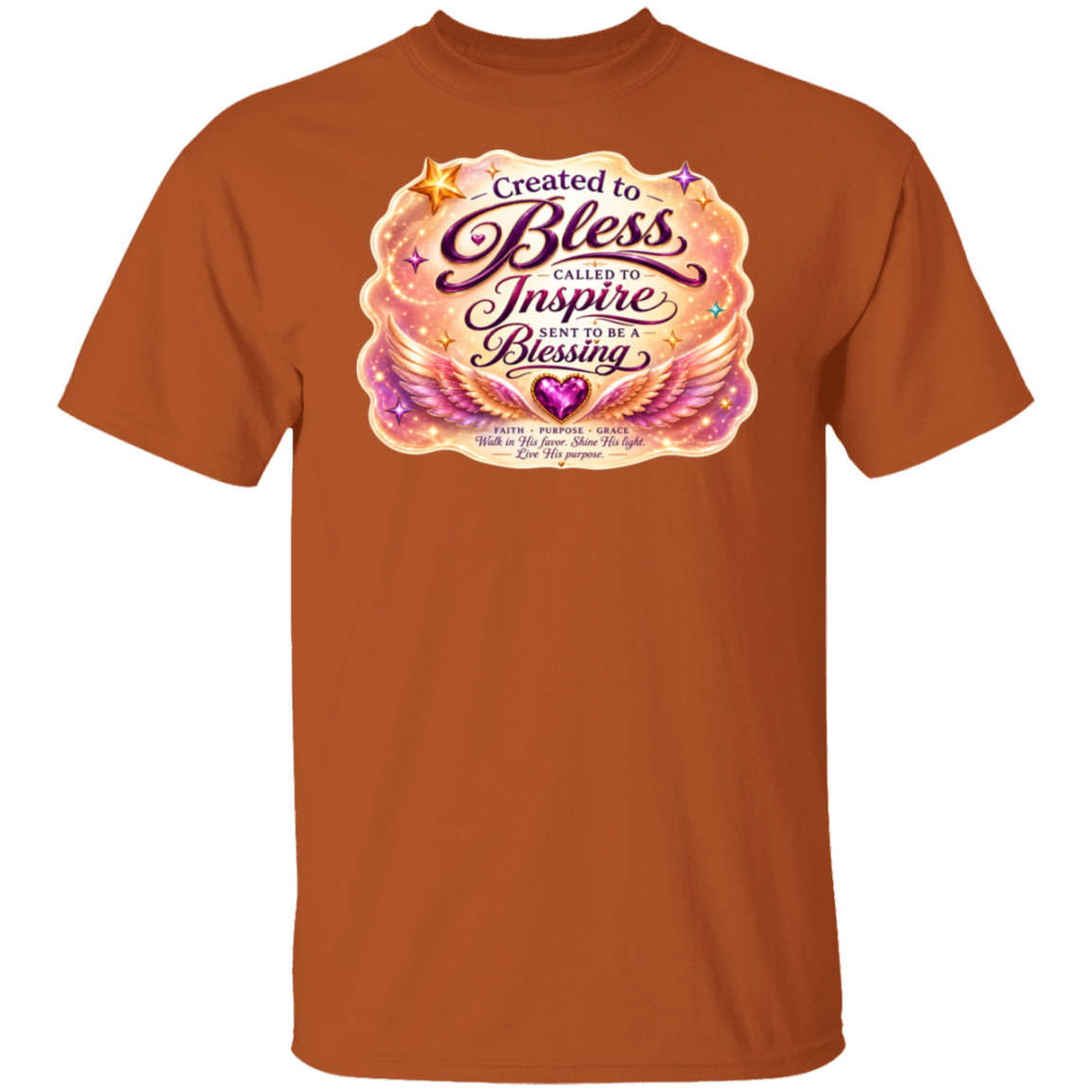 A texas-orange short-sleeve crewneck t-shirt featuring a colorful graphic print on the chest with the text 'Created to Bless Called to Inspire Love in the Blessing' surrounded by pink, purple, and gold angel wings and stars.